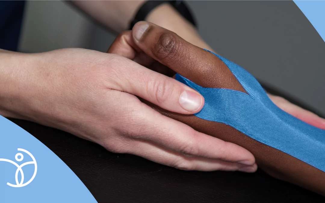 Physiotherapist supporting a patient's hand during treatment, reflecting The Lamberti Way of patient-centred physiotherapy.